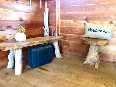 a wooden bench in the corner of a room at A Casetta in Pianottoli-Caldarello