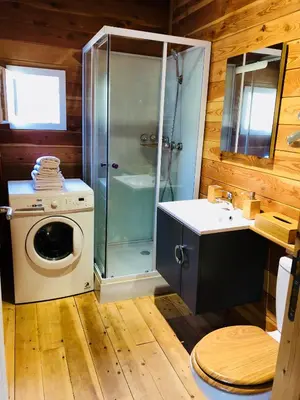 a bathroom with a shower and a washing machine at A Casetta in Pianottoli-Caldarello