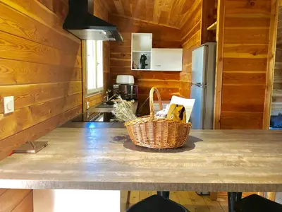a kitchen with a table with a basket on it at A Casetta in Pianottoli-Caldarello