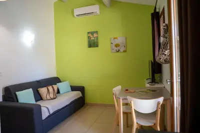 a living room with a couch and a table at Résidence Sophia in Bonifacio
