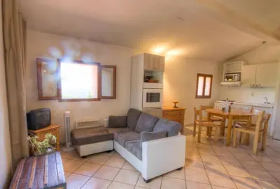 a living room with a couch and a table at A Pivarella in Grosseto-Prugna