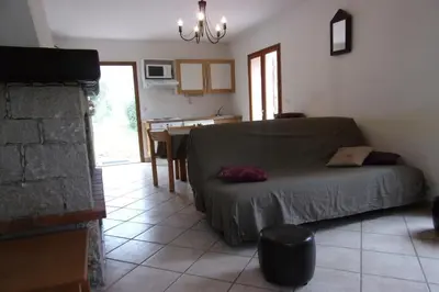 a living room with a bed and a dining room at A Pivarella in Grosseto-Prugna