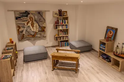 a living room filled with furniture and a book shelf at Villa 18 in Porto-Vecchio