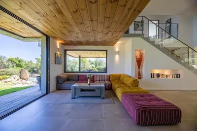 a living room with a couch and a table at Villa 18 in Porto-Vecchio