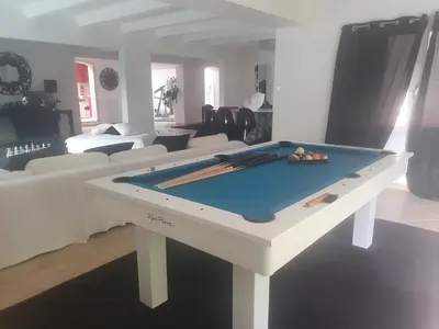 a living room with a pool table in the middle at Villa Petra Bianca Suites & Chambres in Bonifacio
