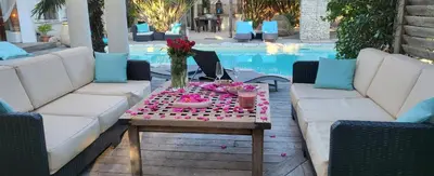 a table with a tray of food and flowers on it at Villa Petra Bianca Suites & Chambres in Bonifacio