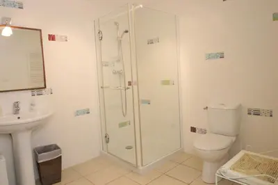 a bathroom with a shower and a toilet and a sink at Villa Ghiatone in Pietrosella