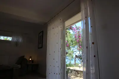 a room with a sliding glass door with a window at Villa Ghiatone in Pietrosella