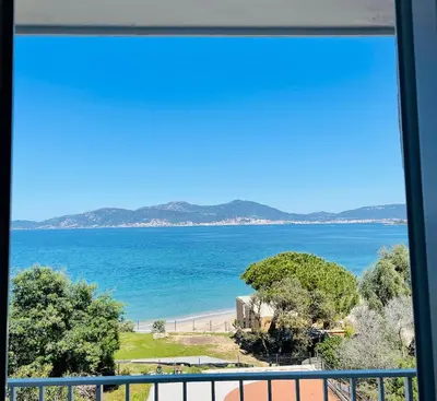 a view of the ocean from a window at Hotel l'Isolella in Porticcio