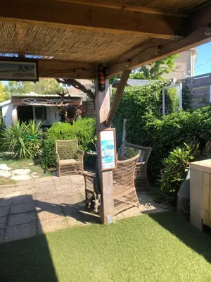 a patio with two wicker chairs under a pergola at Maison du bonheur in Borgo