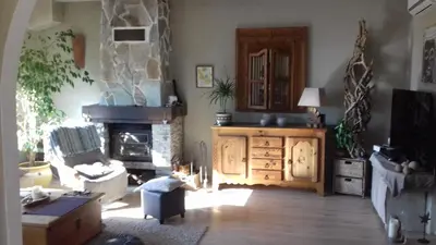a living room with a stone fireplace and a couch at Maison du bonheur in Borgo