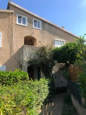 a large brick building with bushes in front of it at Maison du bonheur in Borgo