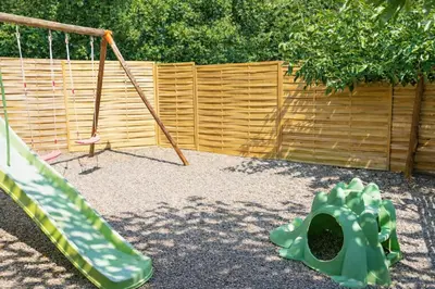 a playground with a swing and a slide at Pianotolu - Rez de villa entre mer et montagne in Moltifao