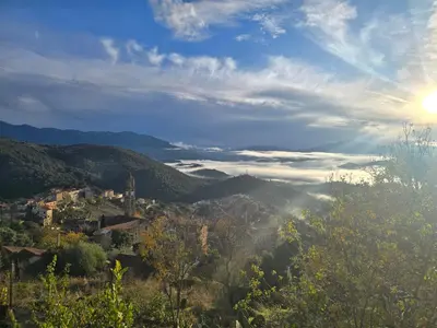 a view of a valley with the sun in the sky at Pianotolu - Rez de villa entre mer et montagne in Moltifao