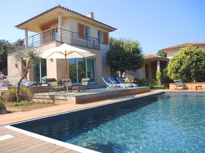 a house with a swimming pool in front of a house at Les Hauts de la Testa in Sainte-Lucie de Porto-Vecchio