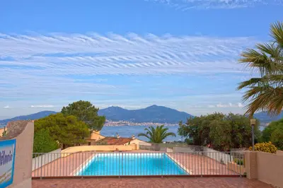 a swimming pool with a view of the water at Porticcio Terra Bella in Porticcio