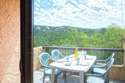 a white table and chairs on a balcony at Porticcio Terra Bella in Porticcio