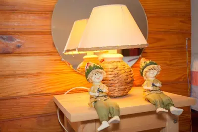 two dolls sitting on a table next to a lamp at Porticcio Terra Bella in Porticcio