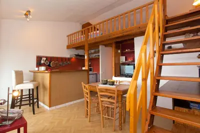 a kitchen and dining room with a loft bed at Porticcio Terra Bella in Porticcio