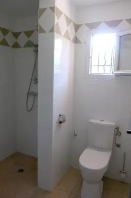 a bathroom with a toilet and a window at Résidence de Tourisme Mare e Macchia in Tizzano