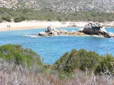 a view of a beach with rocks in the water at Résidence de Tourisme Mare e Macchia in Tizzano