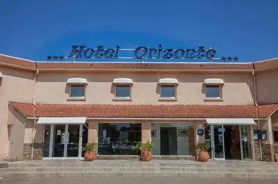 a hotel entrance with a sign on top of it at Orizonte in Cervione