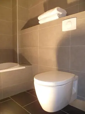 a bathroom with a white toilet and a sink at Orizonte in Cervione