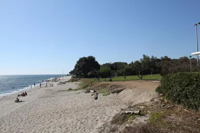 a group of people on a beach near the ocean at Orizonte in Cervione