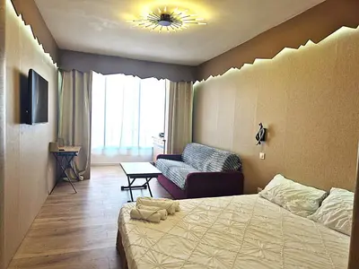 a hotel room with a bed and a couch at Hôtel le Colibri in Lucciana