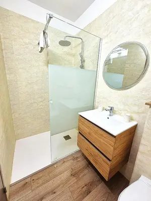 a bathroom with a shower and a sink and a mirror at Hôtel le Colibri in Lucciana