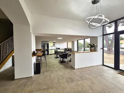 a living room with a kitchen and dining room at Hôtel le Colibri in Lucciana