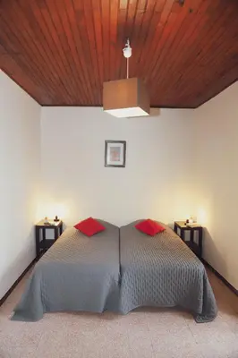 a bedroom with a bed with a wooden ceiling at A Rossa Location in Favone