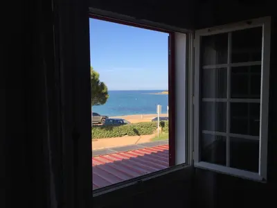 a window view of the ocean from a house at A Rossa Location in Favone