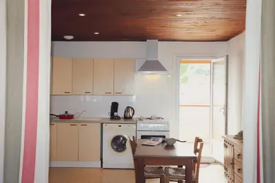 a kitchen with a table and a stove top oven at A Rossa Location in Favone
