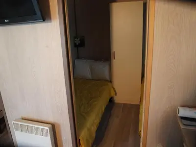 a small room with a small bed in a room at Le petit chalet in Porticcio