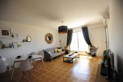 a living room with a couch and a table at T2 Terrasse Vue Mer - Route des Sanguinaires in Ajaccio