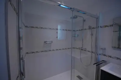 a shower with a glass door in a bathroom at Residence Capicciolo in Olmeto