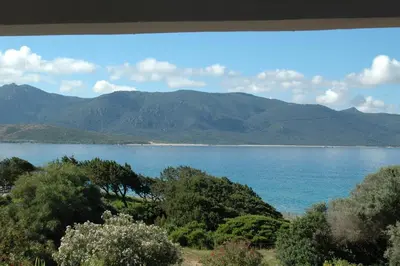 a view of a lake with mountains in the background at Residence Capicciolo in Olmeto