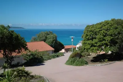 a view of the ocean from a resort at Residence Capicciolo in Olmeto