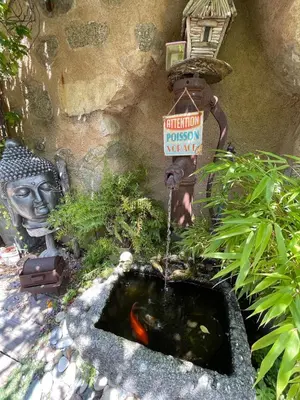 a bird bath with a koi in a garden at Chez Marco Gîte & SPA CAPPELLINA in Muro