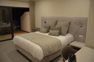 a bedroom with a large bed with pillows at Casa Mare E Vista in Propriano