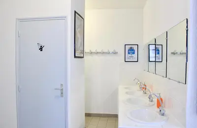a bathroom with three sinks and two mirrors at Gîte du Chalet Pietri in Olivese