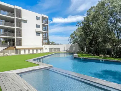 a swimming pool in front of a building at Apartment Résidence Cita di Sali-4 by Interhome in Porto-Vecchio