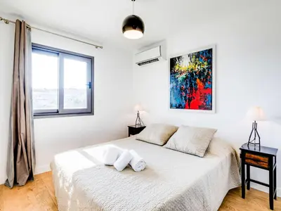 a white bedroom with a bed and a window at Apartment Résidence Cita di Sali-7 by Interhome in Porto-Vecchio