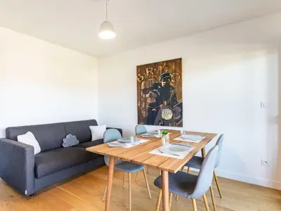 a living room with a table and a couch at Apartment Résidence Cita di Sali-7 by Interhome in Porto-Vecchio