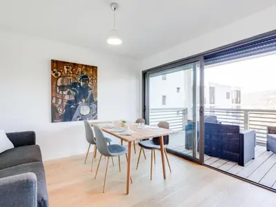 a dining room and living room with a table and chairs at Apartment Résidence Cita di Sali-7 by Interhome in Porto-Vecchio