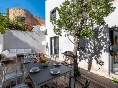 a patio with a table and chairs and a tree at Holiday Home St Cyprien Plage by Interhome in San Ciprianu