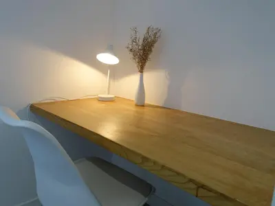 a table with a vase of flowers and a lamp on it at Holiday Home St Cyprien Plage by Interhome in San Ciprianu