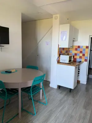a kitchen with a table and chairs in a room at Villa La Viva Porticcio in Porticcio