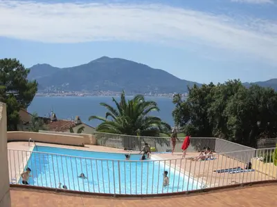 a group of people standing around a swimming pool at Villa La Viva Porticcio in Porticcio